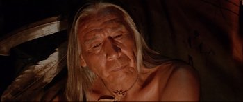Movie still from “Dances with Wolves” (1990), directed by Kevin Costner – An old man with long hair and a necklace; Close Up shot, Low angle
