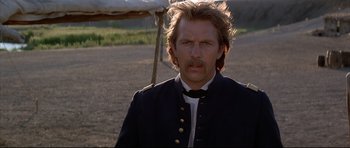 Movie still from “Dances with Wolves” (1990), directed by Kevin Costner – A person wearing a uniform; Close Up shot, Over the shoulder angle
