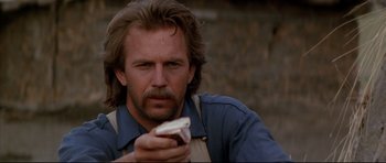 Movie still from “Dances with Wolves” (1990), directed by Kevin Costner – A person holding a cell phone; Close Up shot, Low angle