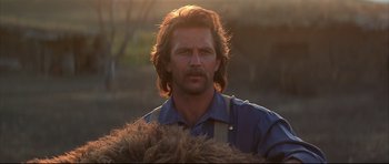 Movie still from “Dances with Wolves” (1990), directed by Kevin Costner – A person wearing a shirt; Close Up shot, Over the shoulder angle