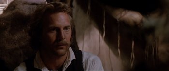 Movie still from “Dances with Wolves” (1990), directed by Kevin Costner – A person wearing a vest; Close Up shot, Over the shoulder angle