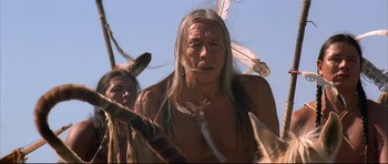Movie still from “Dances with Wolves” (1990), directed by Kevin Costner – Two native american men in traditional clothing and feathers; Close Up shot, Low angle