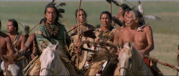Movie still from “Dances with Wolves” (1990), directed by Kevin Costner – A group of native americans riding on horseback; Medium shot, Low angle