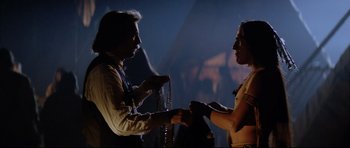 Movie still from “Dances with Wolves” (1990), directed by Kevin Costner – A man and a woman are holding hands and talking; Medium shot, Over the shoulder angle