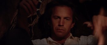 Movie still from “Dances with Wolves” (1990), directed by Kevin Costner – A person wearing a white shirt; Close Up shot, Low angle