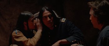 Movie still from “Dances with Wolves” (1990), directed by Kevin Costner – A man and a woman sitting next to each other; Close Up shot, Over the shoulder angle