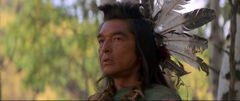Movie still from “Dances with Wolves” (1990), directed by Kevin Costner – A person wearing a headdress; Close Up shot, Over the shoulder angle