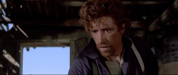 Movie still from “Dances with Wolves” (1990), directed by Kevin Costner – A person with curly hair and a beard; Close Up shot, Low angle