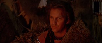 Movie still from “Dances with Wolves” (1990), directed by Kevin Costner – A man with long brown hair wearing a fur coat; Close Up shot, Low angle