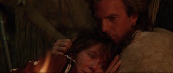 Movie still from “Dances with Wolves” (1990), directed by Kevin Costner – A man and a woman are combing each other's hair; Close Up shot, High angle