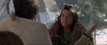 Movie still from “Dances with Wolves” (1990), directed by Kevin Costner – A man in a native american costume looking at another man; Close Up shot, Over the shoulder angle