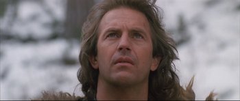 Movie still from “Dances with Wolves” (1990), directed by Kevin Costner – A person with long hair looking up; Close Up shot, Low angle