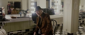 Movie still from “Danny Collins” (2015), directed by Dan Fogelman – An older man sitting in front of a mirror in a dressing room; Medium shot, High angle