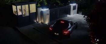 Movie still from “Danny Collins” (2015), directed by Dan Fogelman – A car parked in a driveway at night; Wide shot, High angle