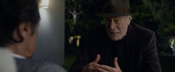 Movie still from “Danny Collins” (2015), directed by Dan Fogelman – An older man wearing a hat talking to someone; Close Up shot, Over the shoulder angle