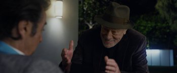 Movie still from “Danny Collins” (2015), directed by Dan Fogelman – An older man wearing a hat is laughing; Close Up shot, Over the shoulder angle
