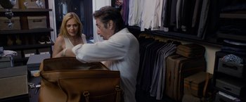 Movie still from “Danny Collins” (2015), directed by Dan Fogelman – A man and a woman are looking at a suit case; Medium shot, Over the shoulder angle