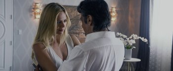 Movie still from “Danny Collins” (2015), directed by Dan Fogelman – A man and a woman standing next to each other; Close Up shot, Over the shoulder angle