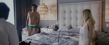 Movie still from “Danny Collins” (2015), directed by Dan Fogelman – A man standing in front of a bed in a bedroom; Wide shot, Over the shoulder angle