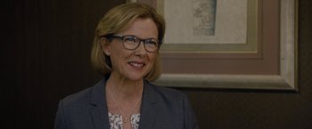 Movie still from “Danny Collins” (2015), directed by Dan Fogelman – A person wearing glasses and a suit; Close Up shot, Over the shoulder angle