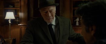 Movie still from “Danny Collins” (2015), directed by Dan Fogelman – An older man wearing a suit and a hat; Close Up shot, Over the shoulder angle