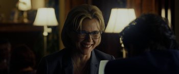 Movie still from “Danny Collins” (2015), directed by Dan Fogelman – A person wearing a suit and glasses; Close Up shot, Over the shoulder angle
