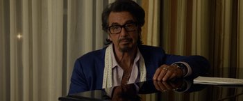 Movie still from “Danny Collins” (2015), directed by Dan Fogelman – A person sitting at a table; Close Up shot, Over the shoulder angle