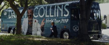 Movie still from “Danny Collins” (2015), directed by Dan Fogelman – A man walking in front of a tour bus; Wide shot, High angle