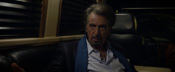 Movie still from “Danny Collins” (2015), directed by Dan Fogelman – An older man sitting in a chair wearing a blue tie; Close Up shot, Over the shoulder angle