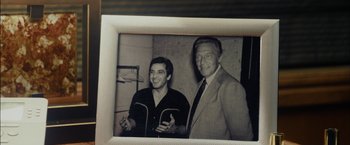 Movie still from “Danny Collins” (2015), directed by Dan Fogelman – An old photo of a man standing next to another man; Close Up shot, High angle