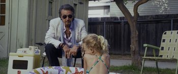 Movie still from “Danny Collins” (2015), directed by Dan Fogelman – An older man sitting next to a little girl; Medium shot, Over the shoulder angle