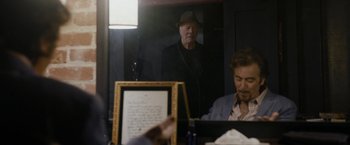 Movie still from “Danny Collins” (2015), directed by Dan Fogelman – An older man wearing a hat looking in a mirror; Medium shot, Over the shoulder angle