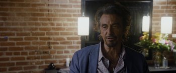 Movie still from “Danny Collins” (2015), directed by Dan Fogelman – A person wearing a suit and tie; Close Up shot, Over the shoulder angle