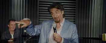 Movie still from “Danny Collins” (2015), directed by Dan Fogelman – An older man holding a microphone in his hand; Close Up shot, Over the shoulder angle