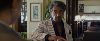 Movie still from “Danny Collins” (2015), directed by Dan Fogelman – An older man in a striped jacket sitting at a table; Close Up shot, Over the shoulder angle
