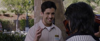 Movie still from “Danny Collins” (2015), directed by Dan Fogelman – A man talking to a woman in front of a brick wall; Close Up shot, Over the shoulder angle