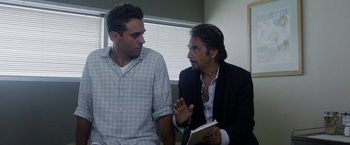 Movie still from “Danny Collins” (2015), directed by Dan Fogelman – Two men are talking to each other in a room; Medium shot, Over the shoulder angle
