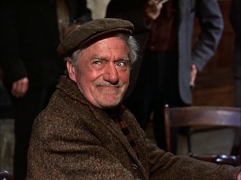 Movie still from “Darby O'Gill and the Little People” (1959), directed by Robert Stevenson – An older man wearing a hat and a blanket; Close Up shot, Low angle