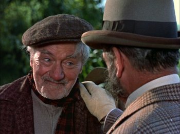 Movie still from “Darby O'Gill and the Little People” (1959), directed by Robert Stevenson – A man in a hat and scarf is looking at another man in a hat and scarf; Close Up shot, Over the shoulder angle