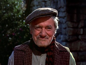 Movie still from “Darby O'Gill and the Little People” (1959), directed by Robert Stevenson – An older man wearing a hat and a scarf; Close Up shot, Low angle