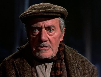 Movie still from “Darby O'Gill and the Little People” (1959), directed by Robert Stevenson – An older man wearing a hat and a scarf; Close Up shot, Low angle