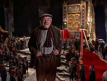 Movie still from “Darby O'Gill and the Little People” (1959), directed by Robert Stevenson – An old man standing in front of a crowd of people; Wide shot, Low angle