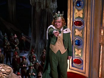 Movie still from “Darby O'Gill and the Little People” (1959), directed by Robert Stevenson – A man dressed as the king points to the audience; Medium shot, Low angle