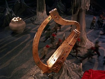 Movie still from “Darby O'Gill and the Little People” (1959), directed by Robert Stevenson – A harp is sitting in the middle of a forest; Wide shot, High angle