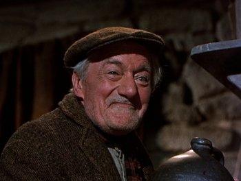 Movie still from “Darby O'Gill and the Little People” (1959), directed by Robert Stevenson – An older man wearing a hat and a jacket; Close Up shot, Low angle