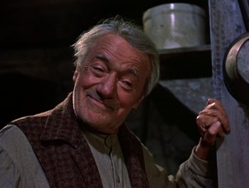 Movie still from “Darby O'Gill and the Little People” (1959), directed by Robert Stevenson – An older man in a brown jacket holding a bucket; Close Up shot, Low angle