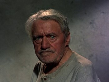 Movie still from “Darby O'Gill and the Little People” (1959), directed by Robert Stevenson – An older man with a gray beard and white hair looking at the camera; Close Up shot, High angle
