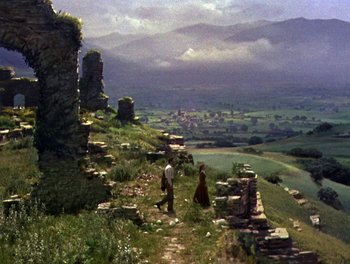 Movie still from “Darby O'Gill and the Little People” (1959), directed by Robert Stevenson – A man and a woman are walking on a hill; Extreme Wide shot, High angle