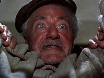 Movie still from “Darby O'Gill and the Little People” (1959), directed by Robert Stevenson – An old man with a hat and a beard; Close Up shot, Overhead angle