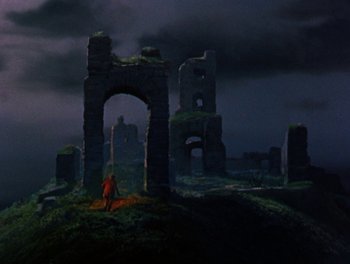 Movie still from “Darby O'Gill and the Little People” (1959), directed by Robert Stevenson – A person standing in front of an old ruin; Extreme Wide shot, Low angle